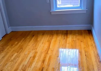 Empty room with spotless hardwood floor after move-out cleaning
