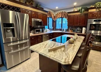 Professionally cleaned residential kitchen with island and stainless-steel appliances